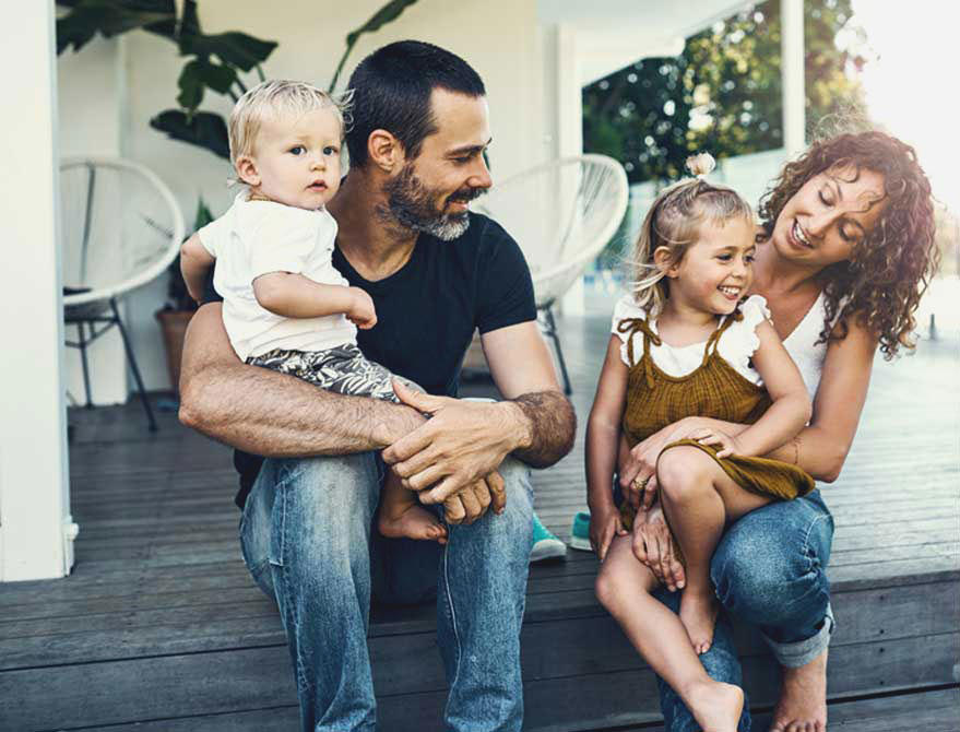 a family sitting on the porch